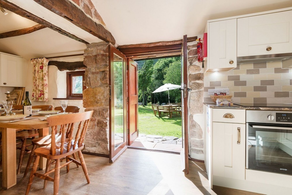 Scafell cottage kitchen, dining area and entrance to our riverside gardens